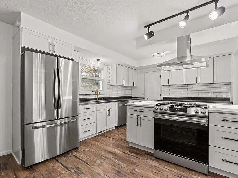 Finished customer kitchen with white Cascade cabinets, subway tile and stainless appliances in Fort Wayne