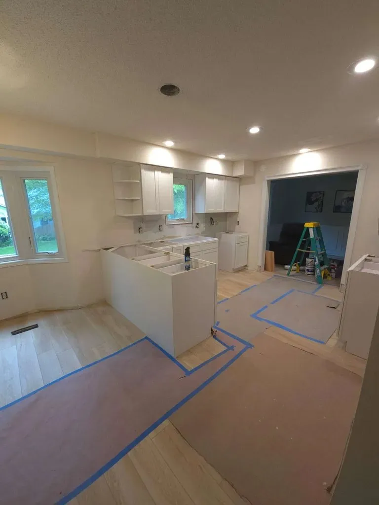 Cabinets going in with the floor papered and taped off
