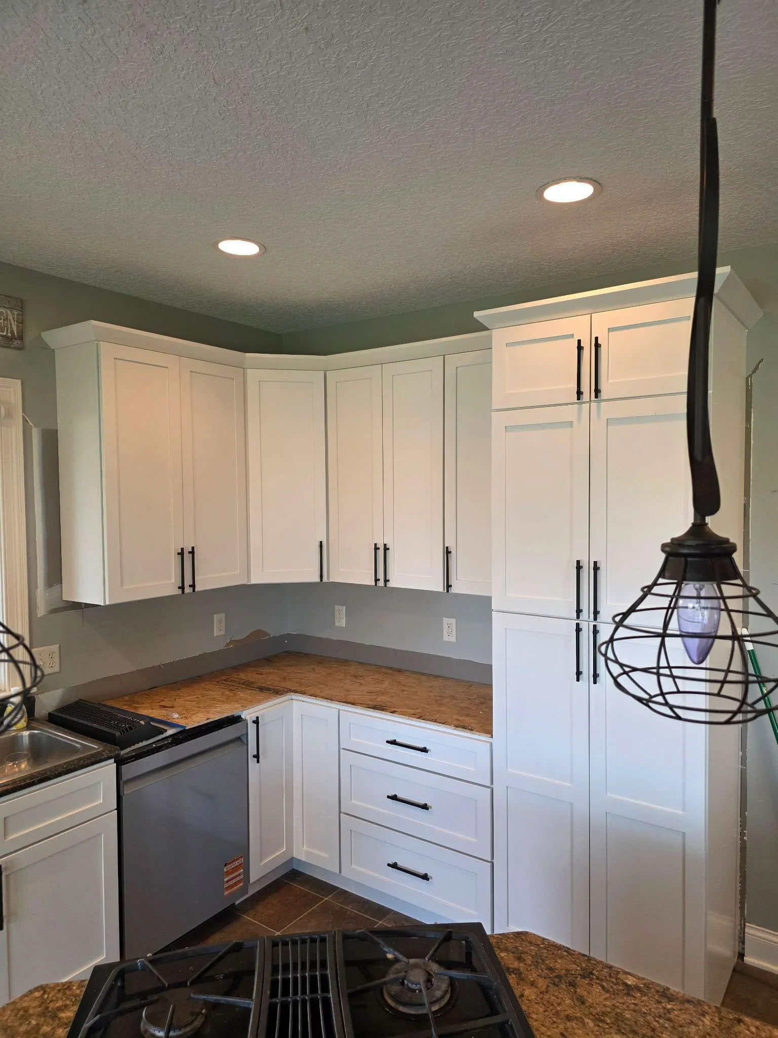 Kitchen being fitted with white Cascade cabinets and a tall pantry in Fort Wayne, Indiana